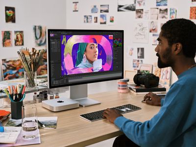 Person using an Apple M2 Pro-powered Mac mini.