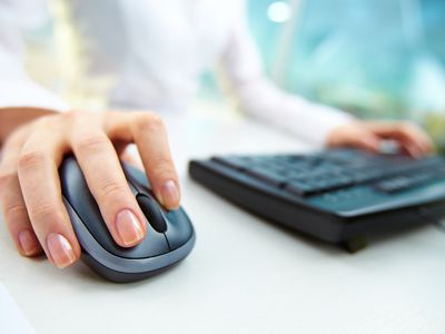 Close up of woman's hand on wireless mouse