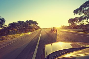 Car on the open road during sunset