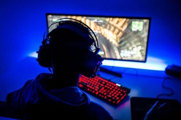 Image of a boy gaming using a large monitor