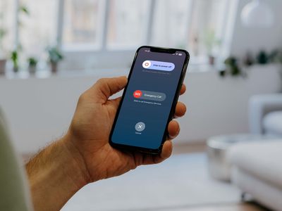 Man holding an iPhone 15 showing the Power Off screen