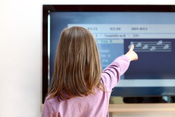 Child in front of television learning app