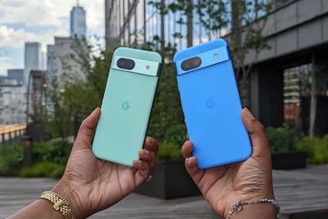 Google Pixel phones held in hands