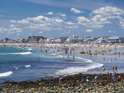 People relaxing on sunny beach, Hampton Beach, New Hampshire, USA.