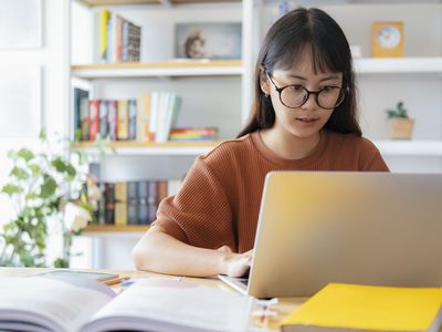 oung collage student using computer and mobile device studying