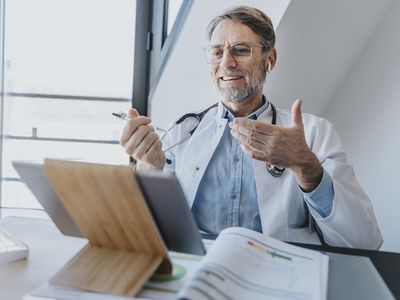 A doctor is in a virtual meeting.