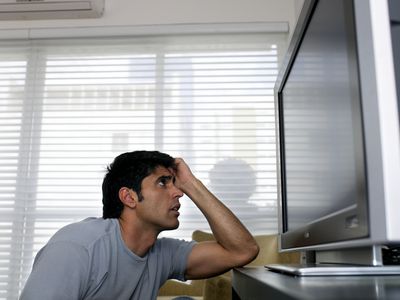 Man frustrated sitting in front of the tv