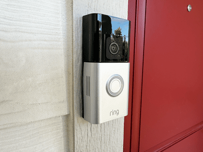 Side view of a Ring Battery Doorbell Plus installed on the front porch